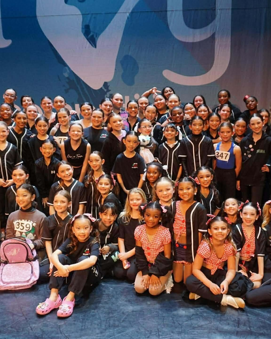 Kick It Up Dance Team dancers gathered together onstage